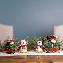 Load image into Gallery viewer, Playful Penguins with Sled Figurine (Set of 2)